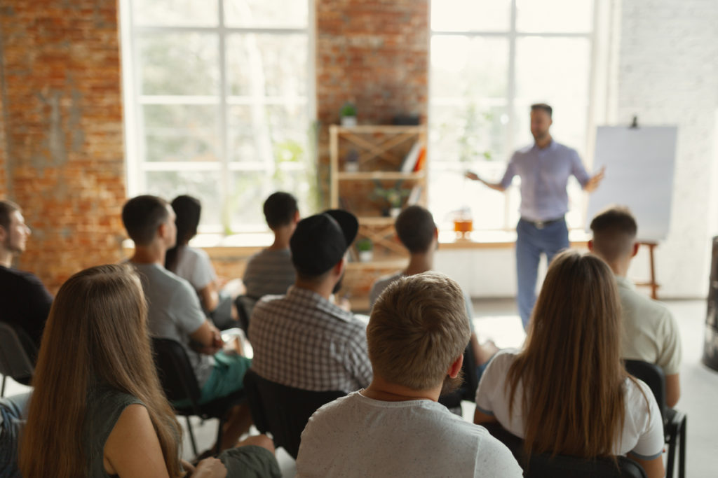 a man is giving a presentation to a group of people.