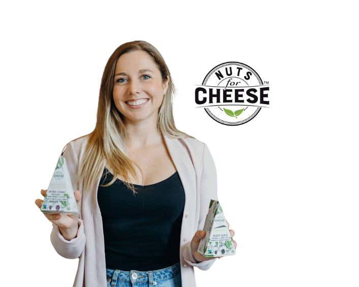 A woman holding cheese bars in her hands smiling